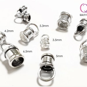May include: Assortment of silver-toned metal end caps for jewelry making. The end caps are available in various sizes, ranging from 3.5 mm to 6.5 mm.  The end caps have a cylindrical shape with a loop at the top.