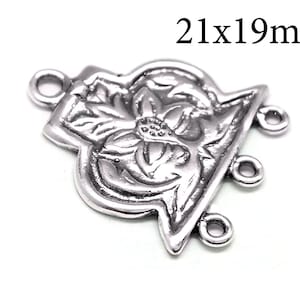 May include: Silver-toned metal connector with a floral design and three jump rings. The connector measures 21x19mm.
