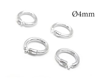May include: Four silver-colored circular jump rings with a hinged opening mechanism. Each ring has a diameter of 4mm as indicated by the text Ø4mm printed in the upper right corner of the image. The rings are arranged in a scattered formation.