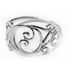 May include: A silver ring with a delicate, intricate design of swirling lines and curves.
