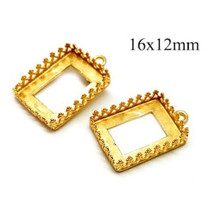 May include: Two gold-toned metal frames with a decorative border. The frames are rectangular and measure 16x12mm. They have a small loop at the top for hanging.