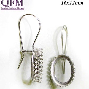 May include: Two silver earring settings with a 16x12mm oval shape. One setting has a decorative crown-like border and the other has a smooth border.