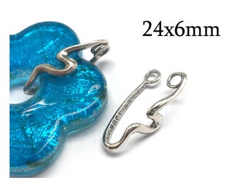 May include: A silver-toned metal clasp with a wavy, elongated shape and two circular loops at one end, measuring 24x6mm. The clasp is positioned next to a bright blue, translucent, flower-shaped glass component with a textured surface.