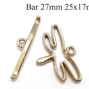 Könnte beinhalten: Goldfarbener Metall-Schiebeverschluss mit Libellen-Design. Der Verschluss misst 25 mm x 17 mm und die Stange ist 27 mm lang.
