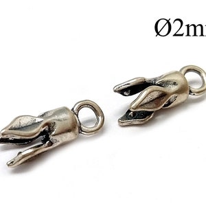 May include: Two silver-toned metal clasps with a leaf design. Each clasp has a small loop for attaching to a chain or cord. The clasps are 2mm in diameter.