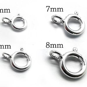 May include: Four silver jump rings in different sizes: 5mm, 6mm, 7mm, and 8mm. The rings are open and have a small loop on one side.