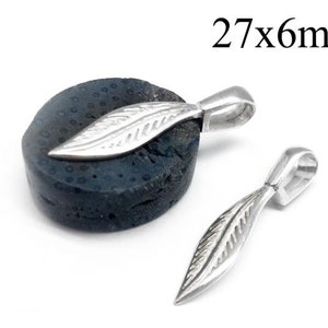 Puede incluir: Pendiente de plata con diseño de hoja, que mide 27 mm por 6 mm. El pendiente se muestra sobre una superficie gris oscuro texturizada.