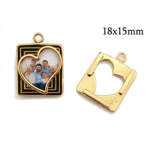 May include: Two gold-colored pendants. One pendant is square with a black border and a heart-shaped cutout holding a family photo. The other pendant is gold with a heart-shaped cutout. The text "18x15mm" is visible.