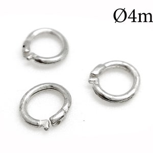 May include: Three silver jump rings, each measuring 4mm in diameter. The rings are open and have a slight gap where they connect.