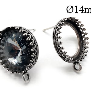 May include: A pair of silver-toned earring settings with a 14mm round bezel. Each setting has a decorative border and a loop for attaching a pendant.