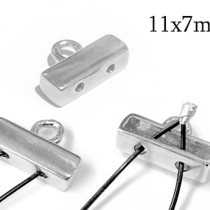 May include: Silver metal toggle clasp with a loop at the top. The clasp is 11mm by 7mm and has two holes for threading cord.