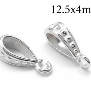 May include: Two silver-toned pendant bails with a textured design. Each bail measures 12.5 mm by 4 mm.