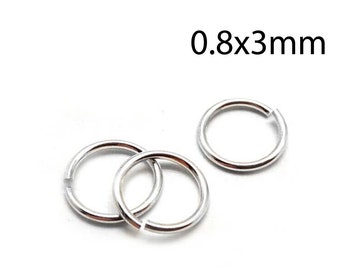 May include: Three silver jump rings, each measuring 0.8 x 3 mm. The rings are open and ready to be used for jewelry making or other crafts.