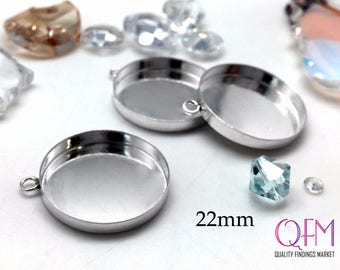 May include: Two silver-toned round metal pendant trays with a 22mm diameter. The trays have a smooth, shiny surface and a small loop at the top for attaching a chain or cord. The text "QFM QUALITY FINDINGS MARKET" is visible in the lower right corner of the image.