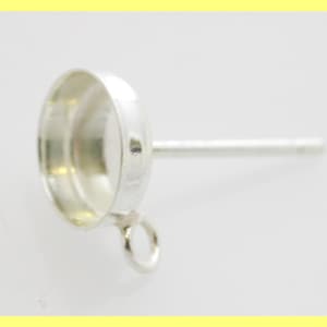 May include: Silver earring setting with a 6 mm round bezel and a loop for attaching a dangle charm.