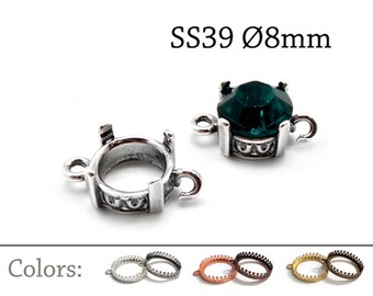 Puede incluir: Dos engastes de metal plateado con anillas a cada lado, uno vacío y otro con una piedra facetada verde oscuro. El texto dice SS39 8mm. Debajo, tres pares de engastes vacíos en tonos plata, cobre y oro están etiquetados como Colors.