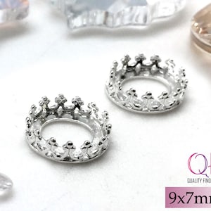 May include: Two silver-toned metal crown-shaped settings for jewelry making. Each piece features a circular base with a raised, notched rim resembling a small crown. The text QFM QUALITY FINDINGS MARKET and 9x7mm are visible.