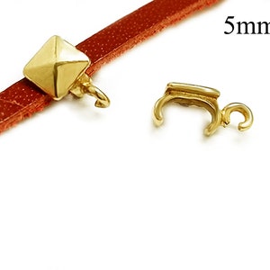 May include: Gold-toned metal clasp with a square pyramid-shaped end. The clasp is 5mm in size and is shown attached to a brown leather strap.