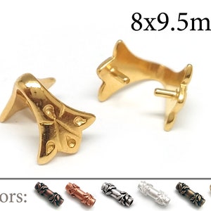May include: Two gold-coloured metal jewellery findings, each with a floral design and a post. The findings measure 8x9.5mm. The image also shows a colour palette of similar findings in various metallic finishes, including bronze, copper, and silver.