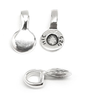 May include: Silver-toned metal pendant bail with a round, flat top and a loop on the side. The back of the bail is stamped with "925" and "THAI".