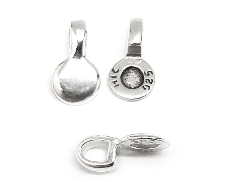 May include: Silver-toned metal pendant bail with a round, flat top and a loop on the side. The back of the bail is stamped with "925" and "THAI".