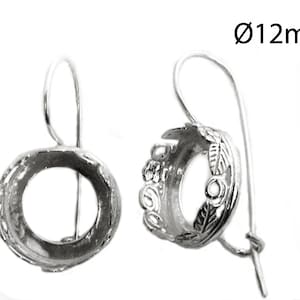 May include: Silver earring settings with a 12mm round opening. The settings have a decorative floral design.