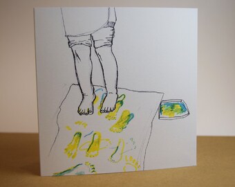 May include: A black and white line drawing of a person making footprints in yellow and green paint on a white surface. A small tray of paint is in the corner of the image.
