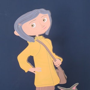 May include: A yellow raincoat with a brown bag and a gray cat with blue eyes. The girl is wearing yellow rain boots and has blue hair.