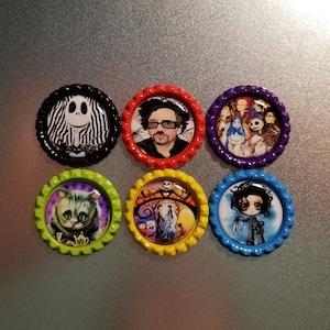 May include: Six round bottle cap magnets with various images from the Tim Burton films Nightmare Before Christmas, The Corpse Bride, and Sweeney Todd. The magnets are in different colors, including black, red, purple, green, yellow, and blue.