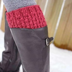 May include: Red knitted leg warmers worn over black leather boots with a buckle.