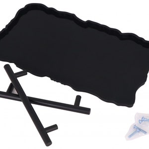 May include: Black tray with an irregular, organic shape, made of silicone. The tray is on a black metal stand with two handles. Two small bags of screws are included.