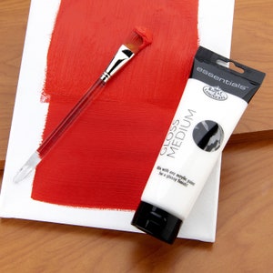 May include: A white tube of Royal & Langnickel essentials&trade; gloss medium for acrylic paint. The tube has black text that reads "essentials&trade;", "GLOSS MEDIUM", "Mix with any acrylic paint for a glossy finish!" and a black and white logo that reads "ROYAL & LANGNICKEL".