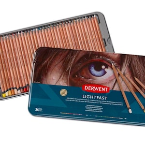 May include: A tin of 36 Derwent Lightfast coloured pencils. The tin has a blue background with a close-up image of an eye. The text "Derwent Lightfast" is printed in white on a red banner.