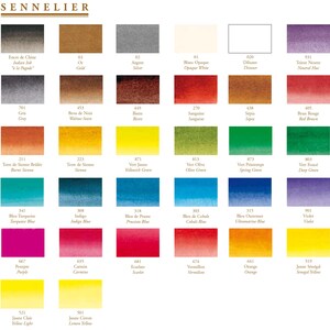 May include: A color chart of Sennelier watercolor paints, featuring a wide array of hues. The chart displays swatches of various colors, including blues, greens, reds, yellows, and browns, with each color labeled with its name and number. The Sennelier logo is at the top.