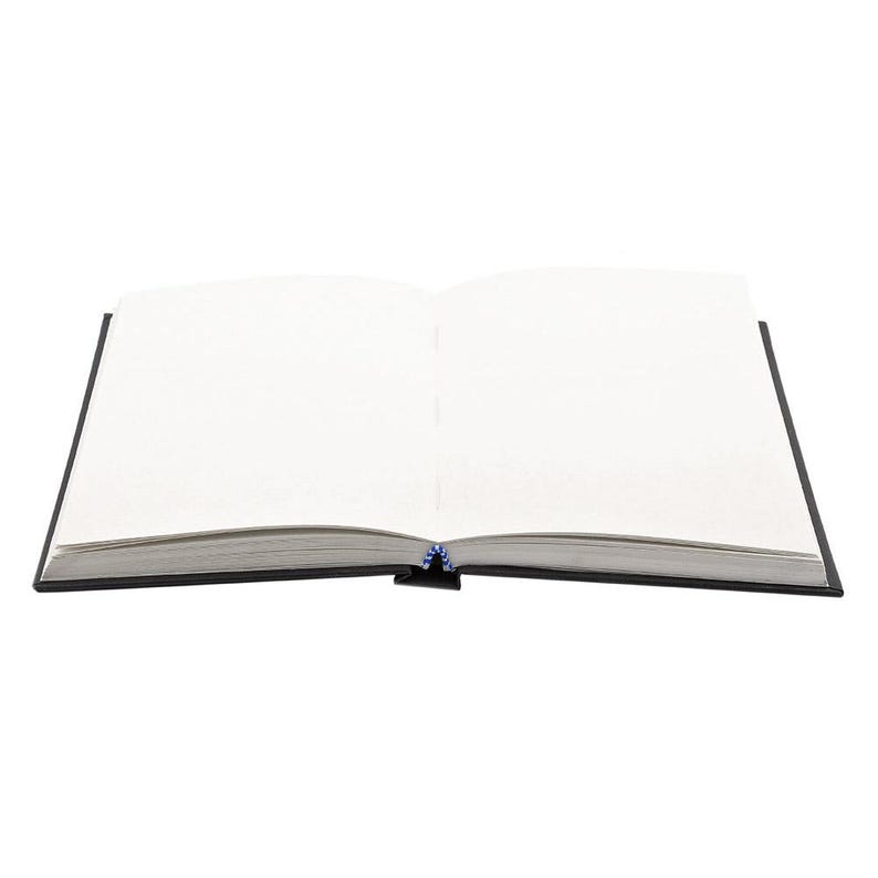 May include: A blank, open book with black covers and white pages. The book is lying flat on a white surface.