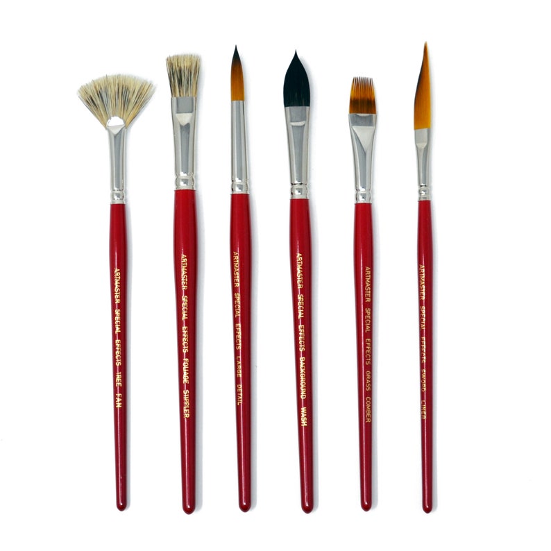 May include: Set of six red handled paint brushes with gold lettering indicating their use. The brushes are labeled "Tree Fan", "Foliage Smudger", "Large Detail", "Background Wash", "Grass Comber", and "Detail Liner".