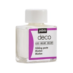 May include: A clear glass bottle with a white cap containing Pebeo Deco Gilding Paste. The bottle label is pink and white and reads "Pebeo Deco Gloss - Brillant - Brillante Gilding paste Mixtion Mixtion".