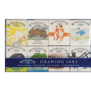 May include: A set of 10 Winsor & Newton drawing inks in a blue box. The inks are in individual boxes with illustrations of various subjects, including a train, a frog, and a ship. The box has the text "Drawing Inks" on the front.