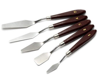 May include: Set of five stainless steel palette knives with brown wooden handles. The handles are numbered 1 through 5.