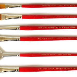 May include: Set of six paint brushes with red handles and silver ferrules. The brushes have different shapes and sizes, including a fan brush, a round brush, and a flat brush. The handles are labeled with the words "Artmaster Special Effects" and the specific brush type.