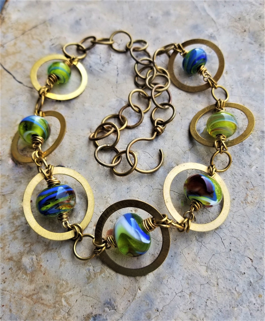 Hand Blown Glass Beads Wirewrapped in Handcut Brushed Brass Circles