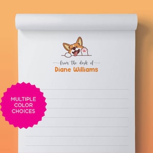 May include: White notepad with lined paper and a cute cartoon corgi peeking over the top. The text "from the desk of Diane Williams" is printed in orange below the corgi.