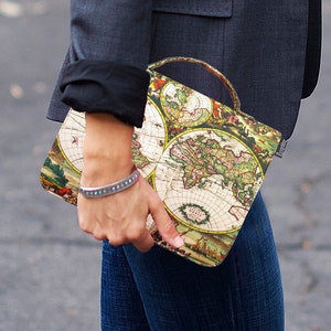 May include: A vintage-style clutch bag with a map print. The bag has a top handle and a flap closure. The map print features a world map with continents and oceans.