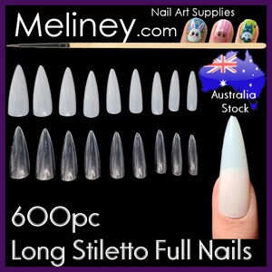 May include: 600 clear long stiletto full cover fake nails. The nails are arranged in rows on a black background. The nails are clear and have a pointed shape. The text "600pc Long Stiletto Full Nails" is at the bottom of the image.