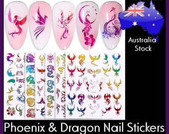 May include: A sheet of colorful nail stickers featuring phoenix and dragon designs. The stickers are on a white background and are ready to be applied to nails.  Meliney.com Australia Stock.