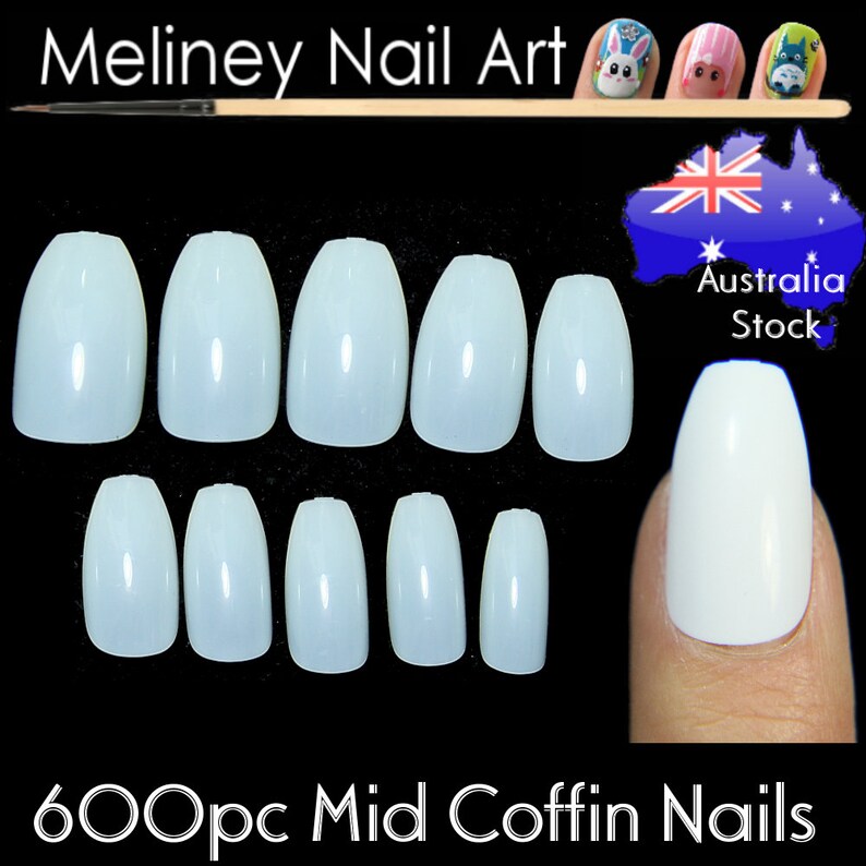 May include: 600 pieces of mid coffin shaped false nails in a light blue color. The nails are arranged in two rows of ten. The image also shows a finger wearing one of the nails.