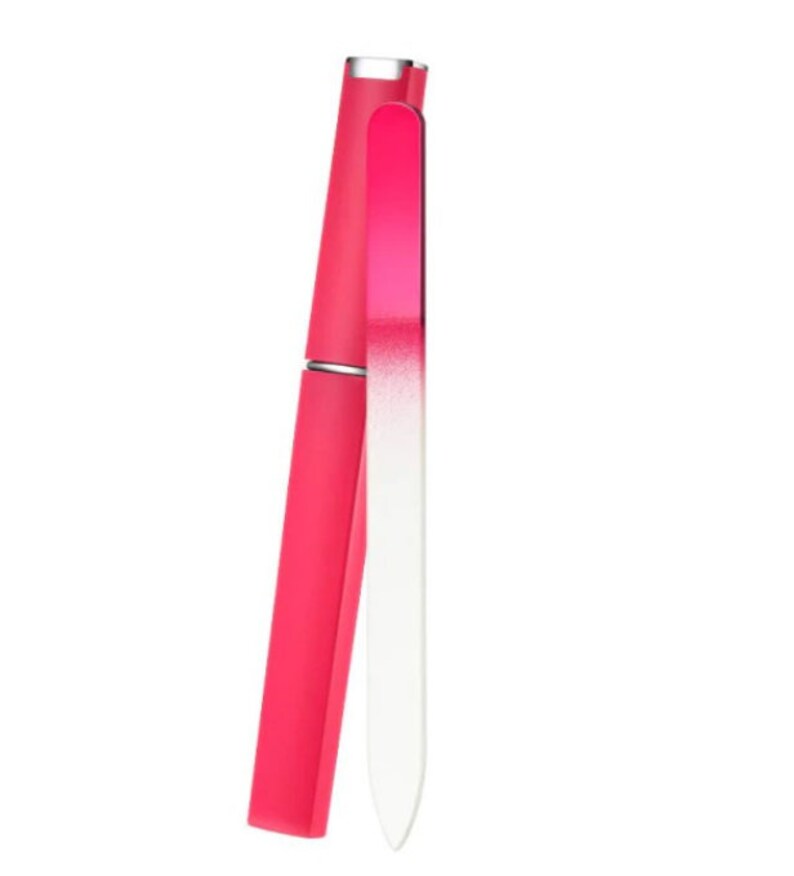 May include: A pink nail file with a white, slightly textured surface. The file is in a protective case.
