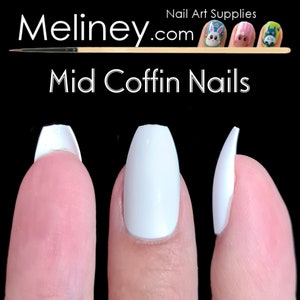 May include: Three white coffin-shaped artificial nails on fingers, showing different lengths. The nails are a mid-length coffin shape.