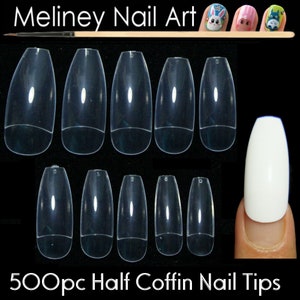 May include: 500 clear half coffin shaped nail tips for nail art. The tips are arranged in rows on a black background. A single white nail tip is shown on a finger.