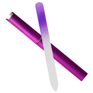 May include: A purple nail file with a clear glass surface and a purple plastic case.